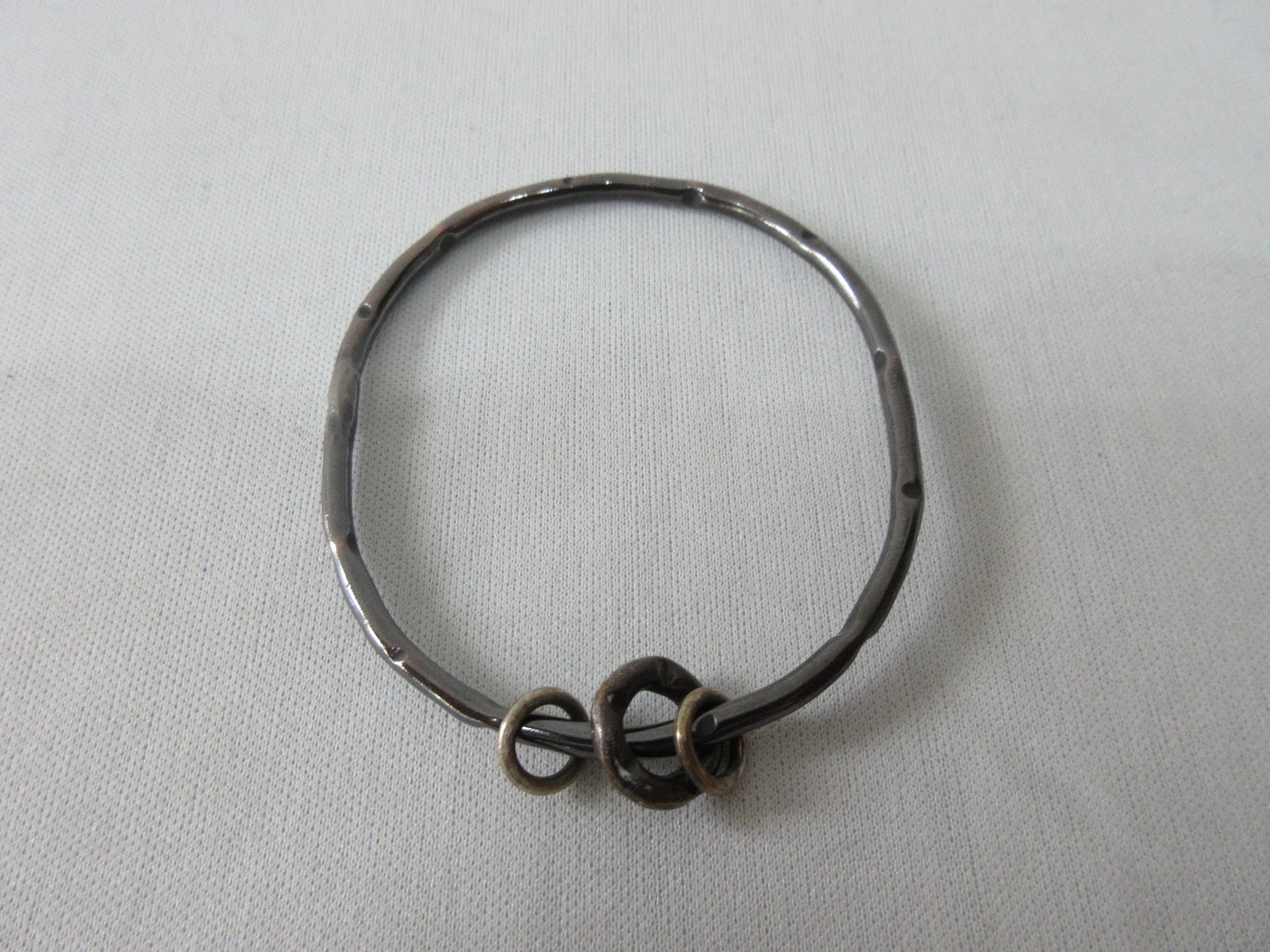 20A44 -Karyn Chopik Dented Dark Silver Bracelet with 3 Small Rings