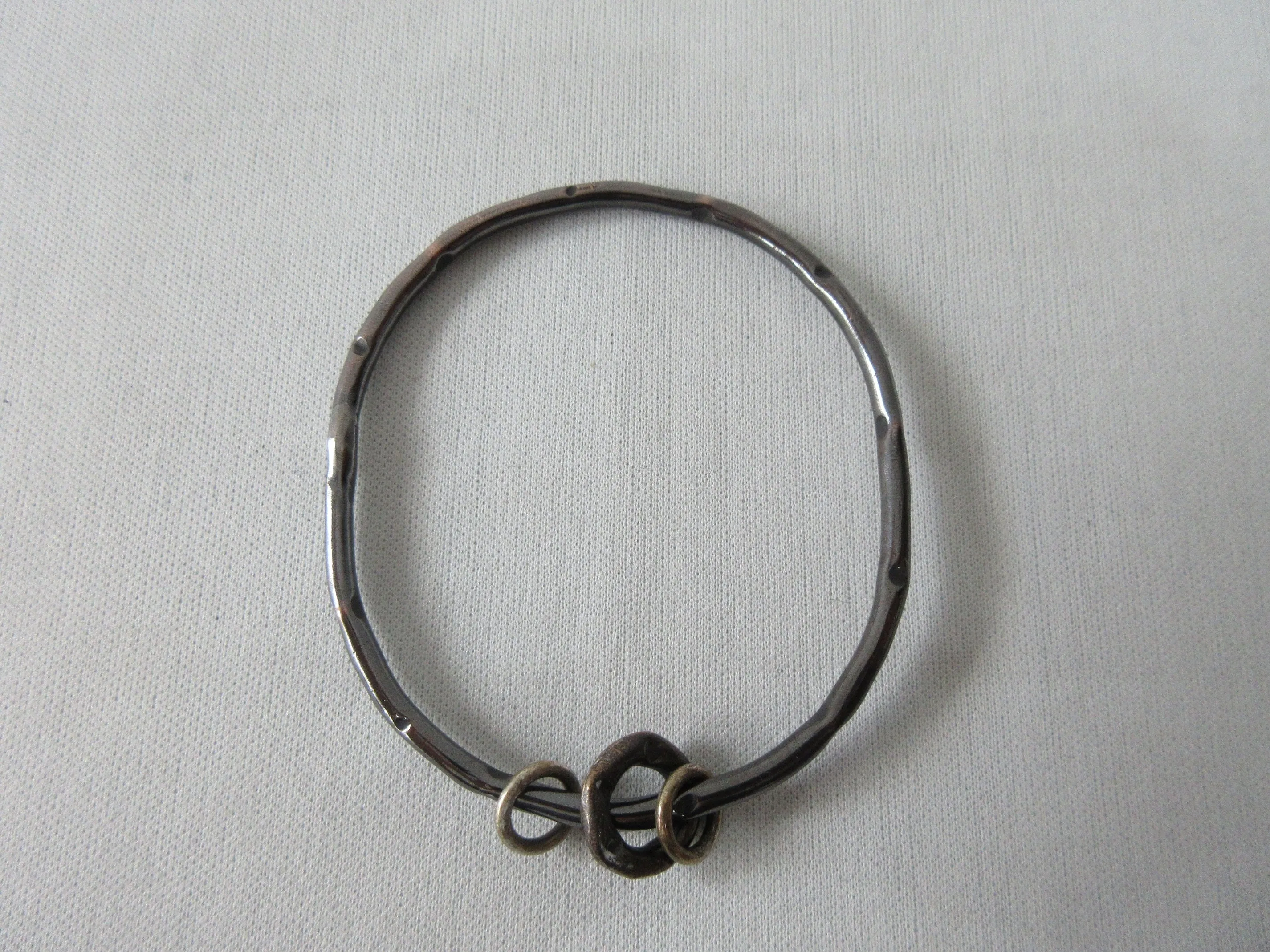 20A44 -Karyn Chopik Dented Dark Silver Bracelet with 3 Small Rings